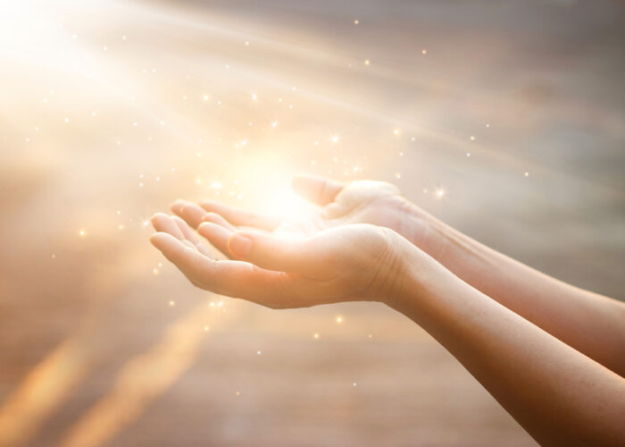 Woman hands praying for blessing from god on sunset background